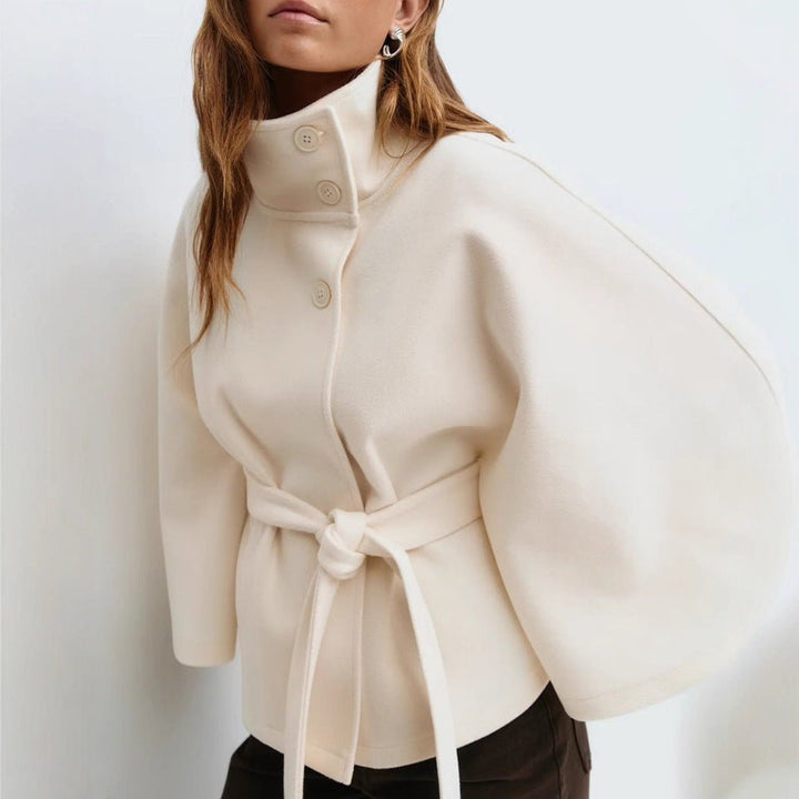https://cdn.shopify.com/s/files/1/0876/2487/6380/files/kouvr-jannah-white-wool-cape-jacket-front-close-up.jpg?v=1772395323
